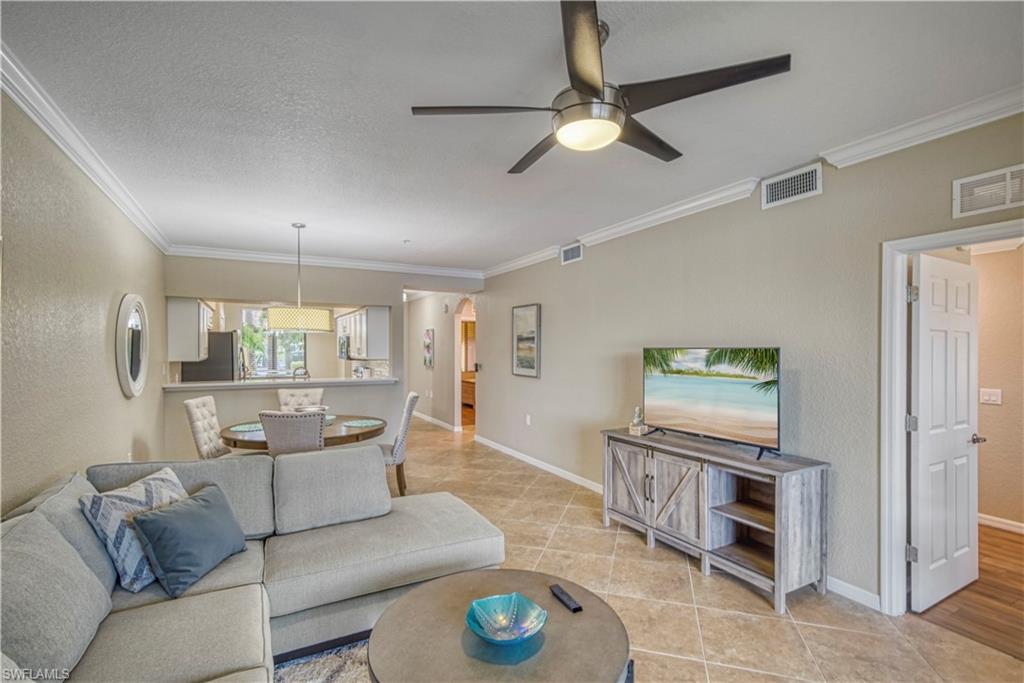 9560 Trevi Court, Unit 4815 Naples, FL 34113 - Photo 15 of 38 a living room with furniture and a table