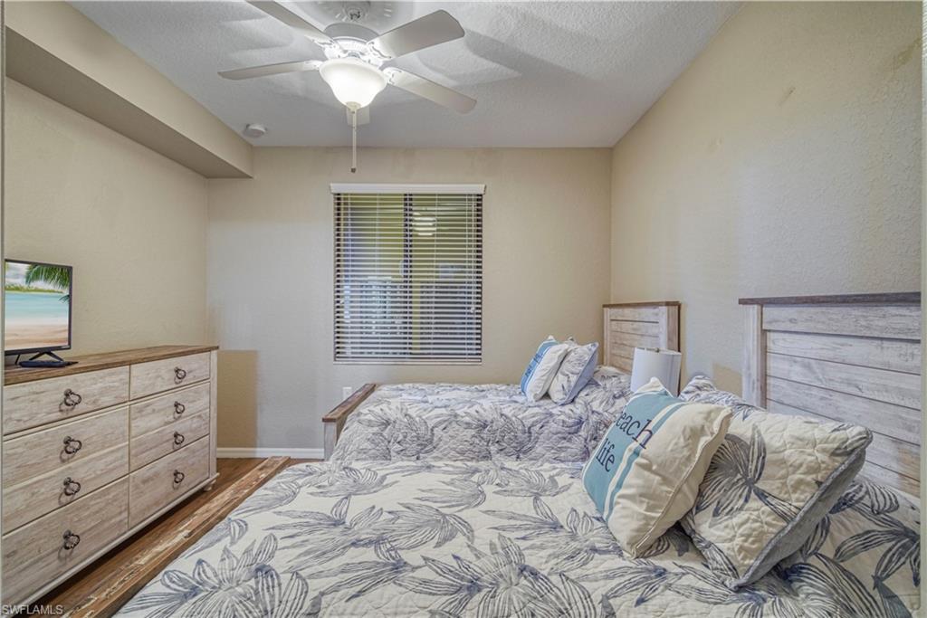 9560 Trevi Court, Unit 4815 Naples, FL 34113 - Photo 21 of 38 a bedroom with a bed and a window