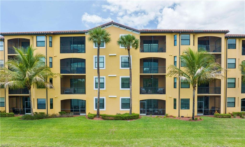 9560 Trevi Court, Unit 4815 Naples, FL 34113 - Photo 25 of 38 a front view of a house with a yard