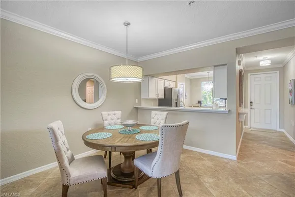 a view of a dining room with furniture a chandelier and wooden floor