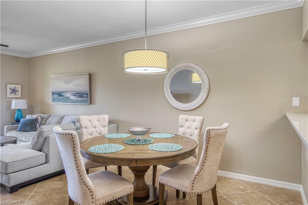 9560 Trevi Court, Unit 4815 Naples, FL 34113 - Photo 5 of 38 a view of a dining room with furniture and a mirror