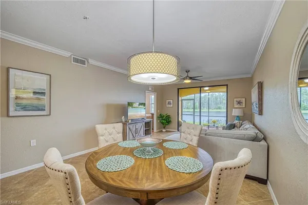 a dining room with furniture and a chandelier