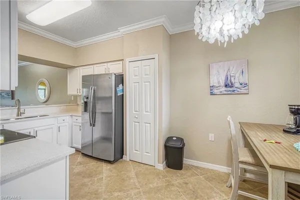 a kitchen with a refrigerator and a sink