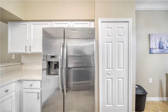 a kitchen with a refrigerator and cabinets