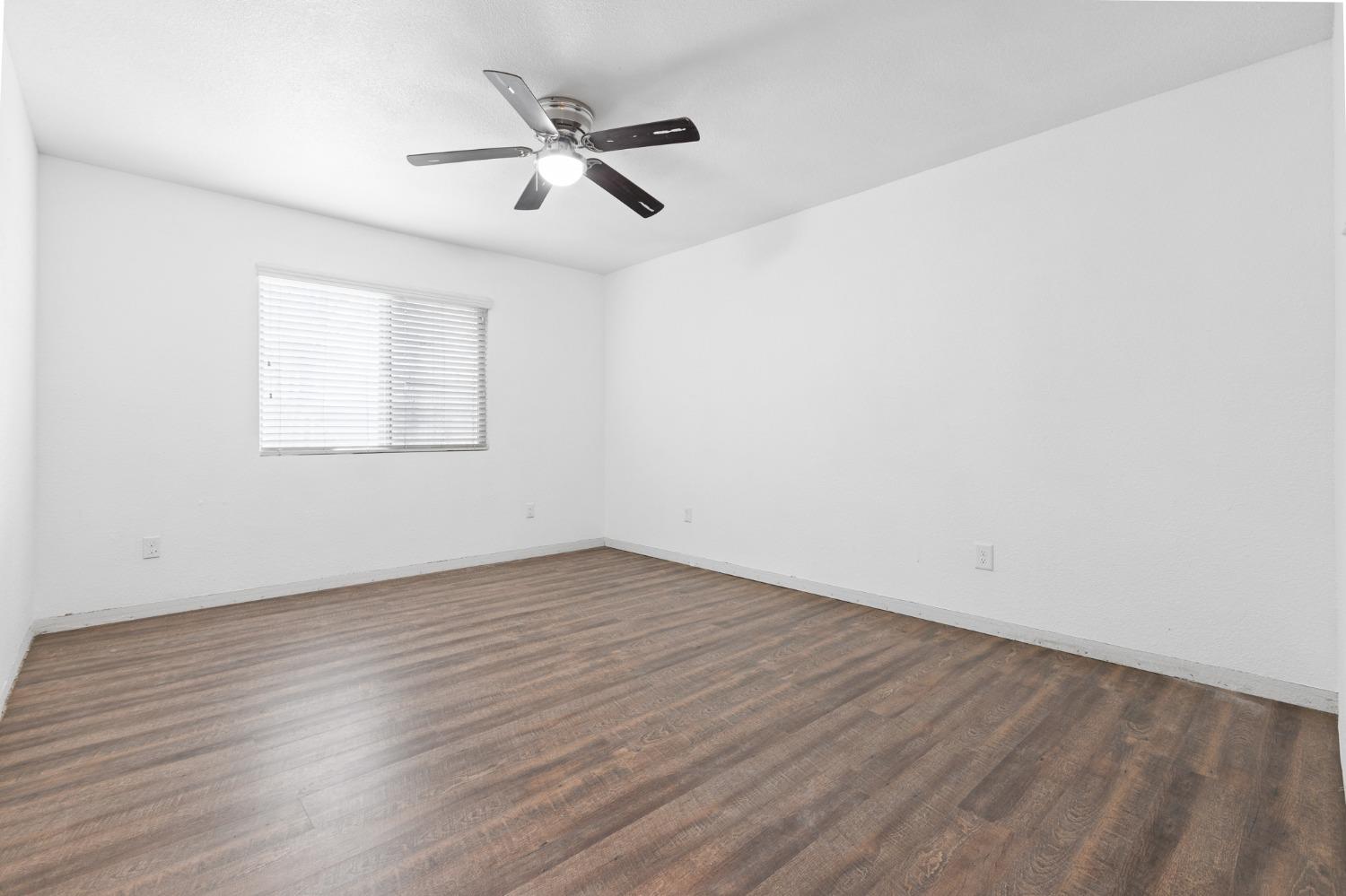 2242 Harvard Avenue Clovis, CA 93612 - Photo 25 of 34 an empty room with wooden floor fan and windows