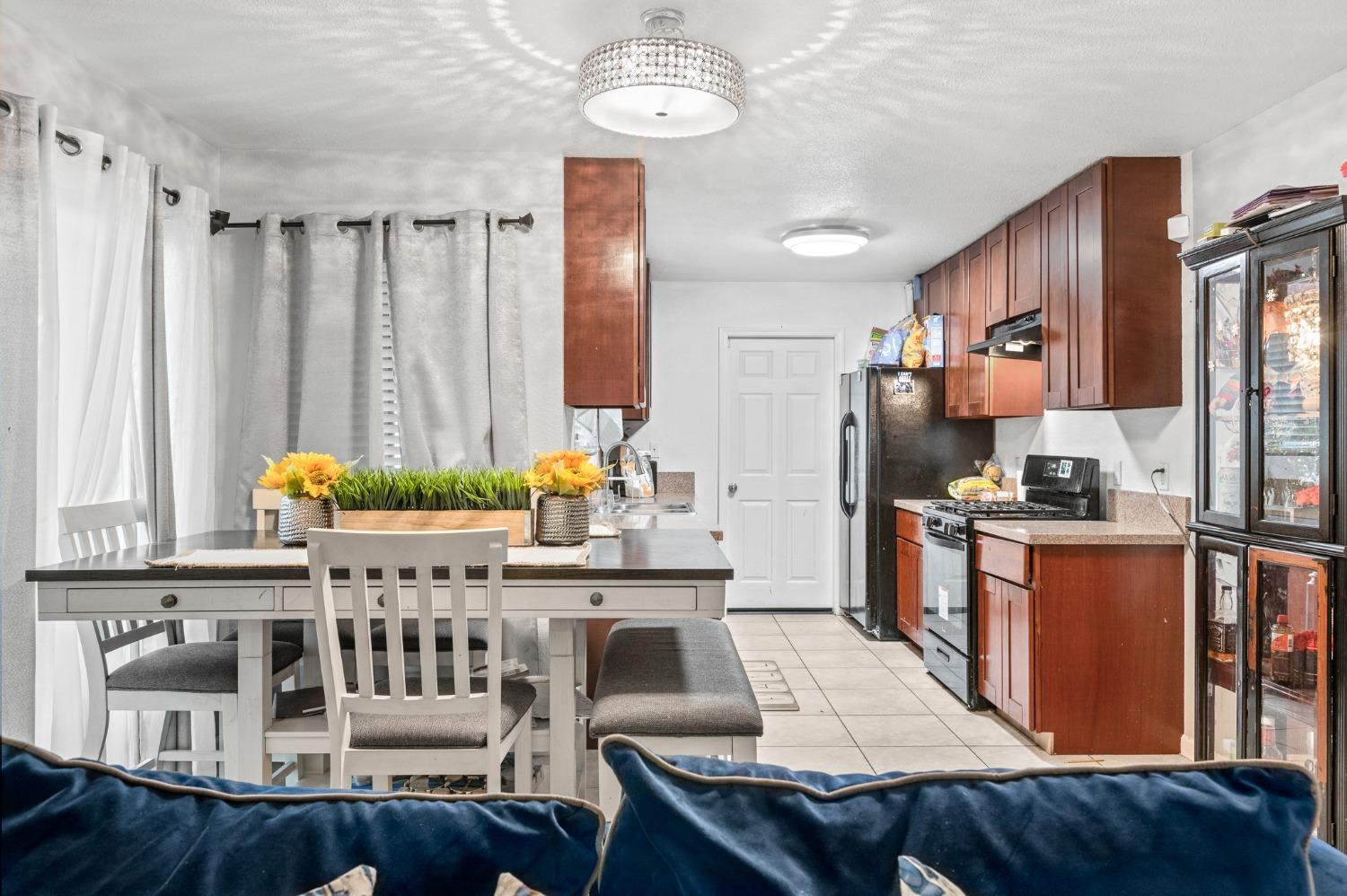 2242 Harvard Avenue Clovis, CA 93612 - Photo 4 of 34 a living room with furniture a chandelier and a dining table