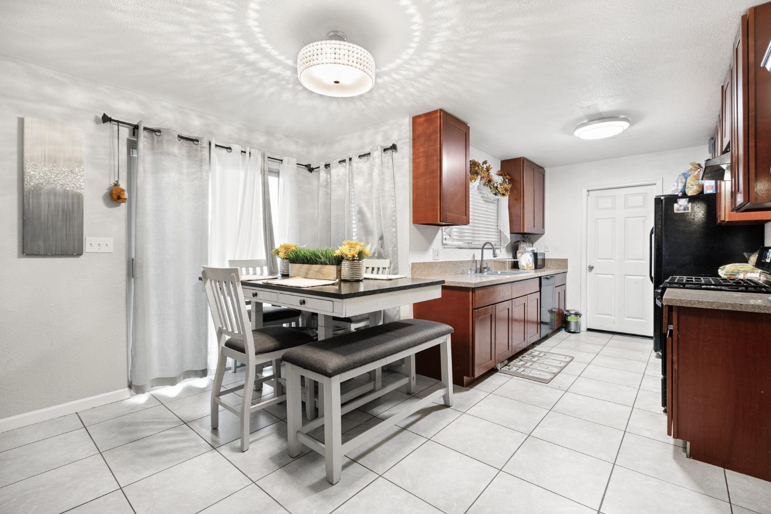 2242 Harvard Avenue Clovis, CA 93612 - Photo 5 of 34 a kitchen with stainless steel appliances a stove a sink and a refrigerator