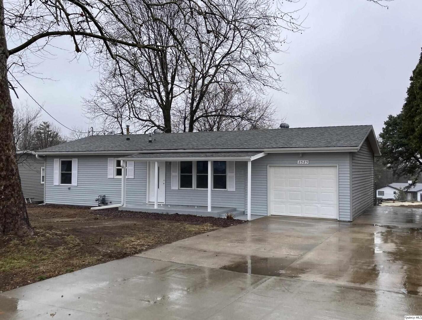 a house that has a tree in front of it