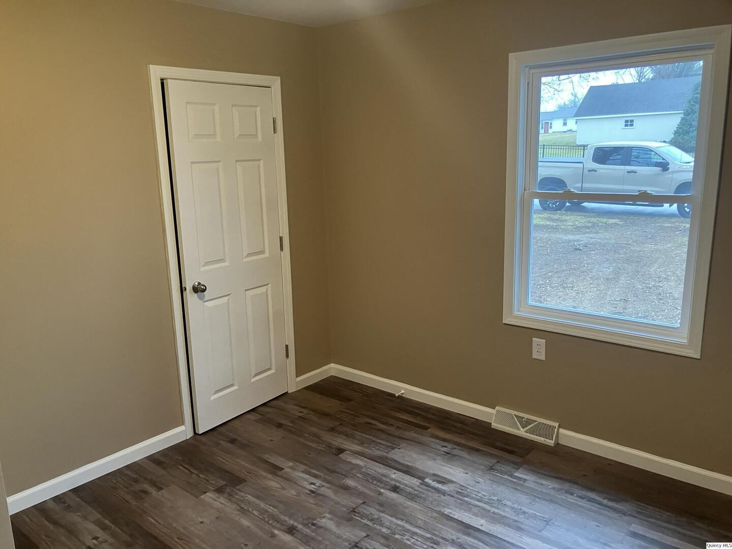 2525 Larch Road Quincy, IL 62301 - Photo 12 of 21 an empty room with wooden floor and windows