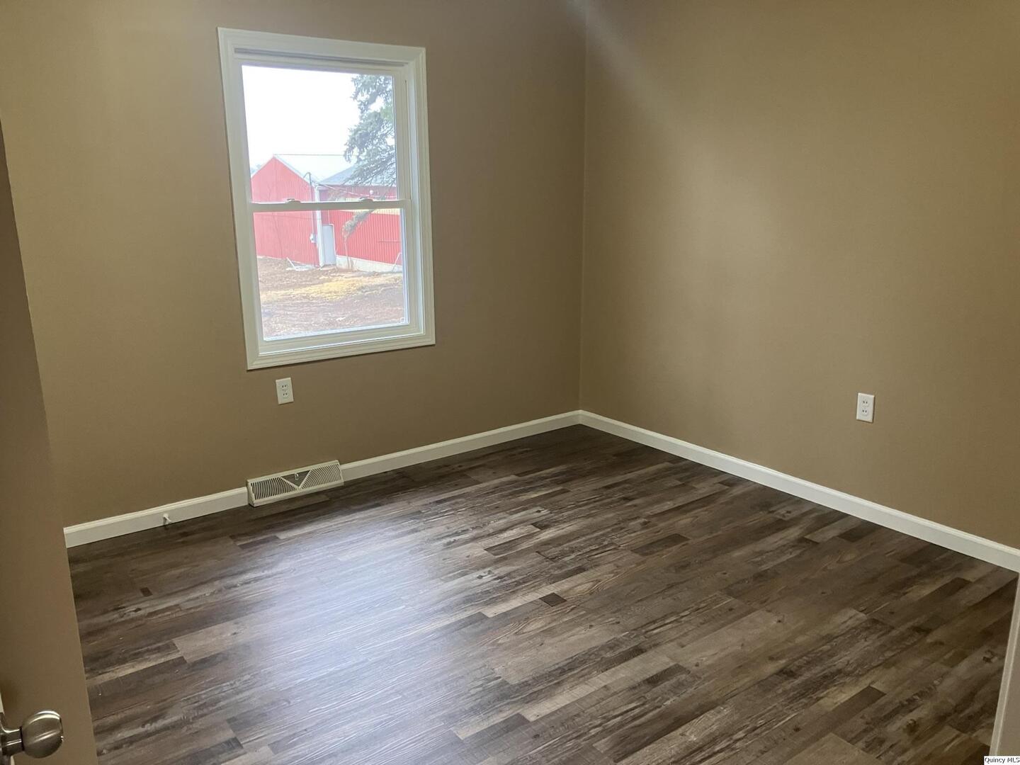 2525 Larch Road Quincy, IL 62301 - Photo 6 of 21 a view of a room with wooden floor and windows