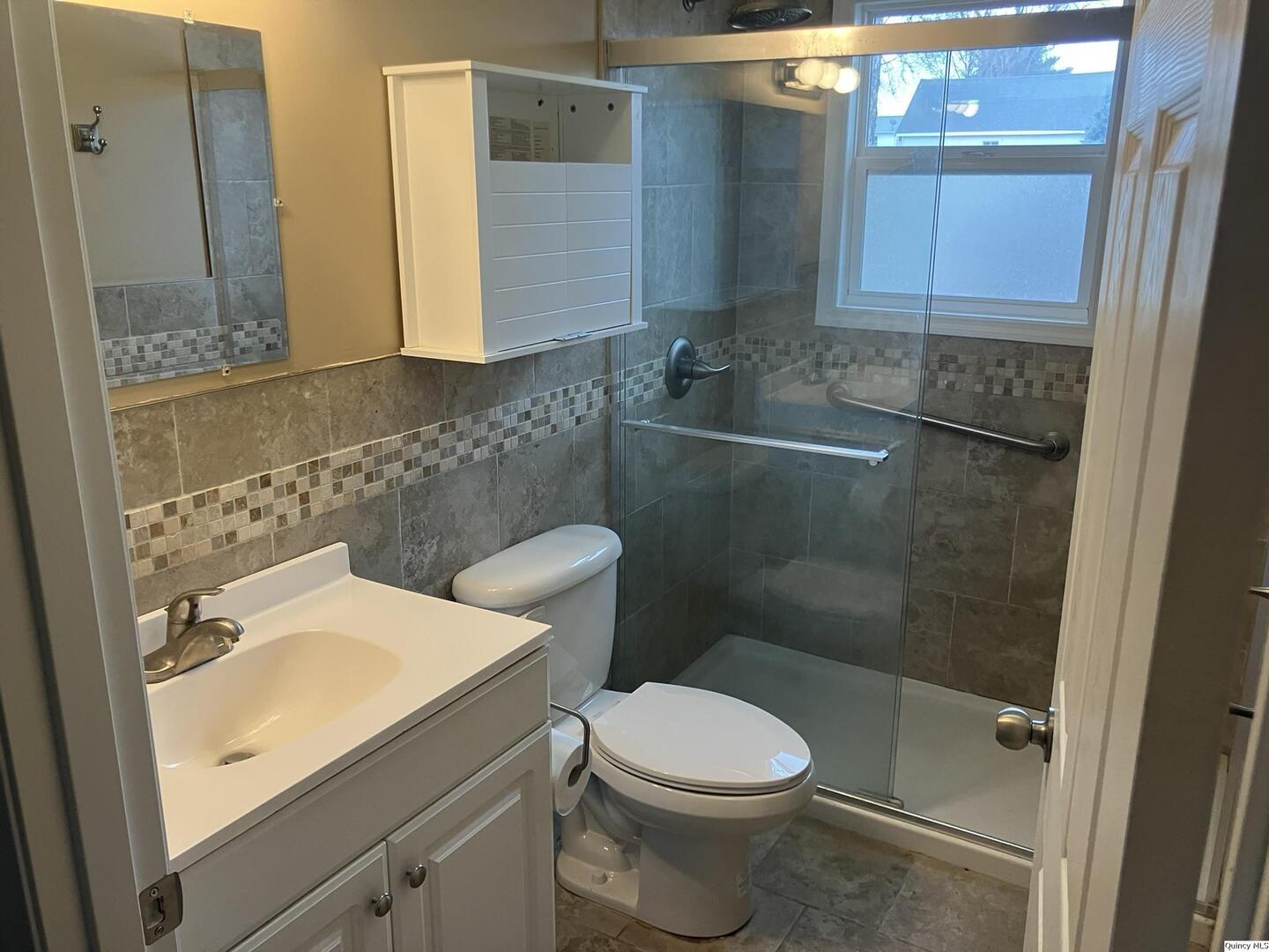 2525 Larch Road Quincy, IL 62301 - Photo 10 of 21 a bathroom with a sink a toilet and shower