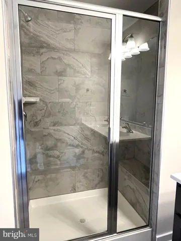 a bathroom with a glass shower door
