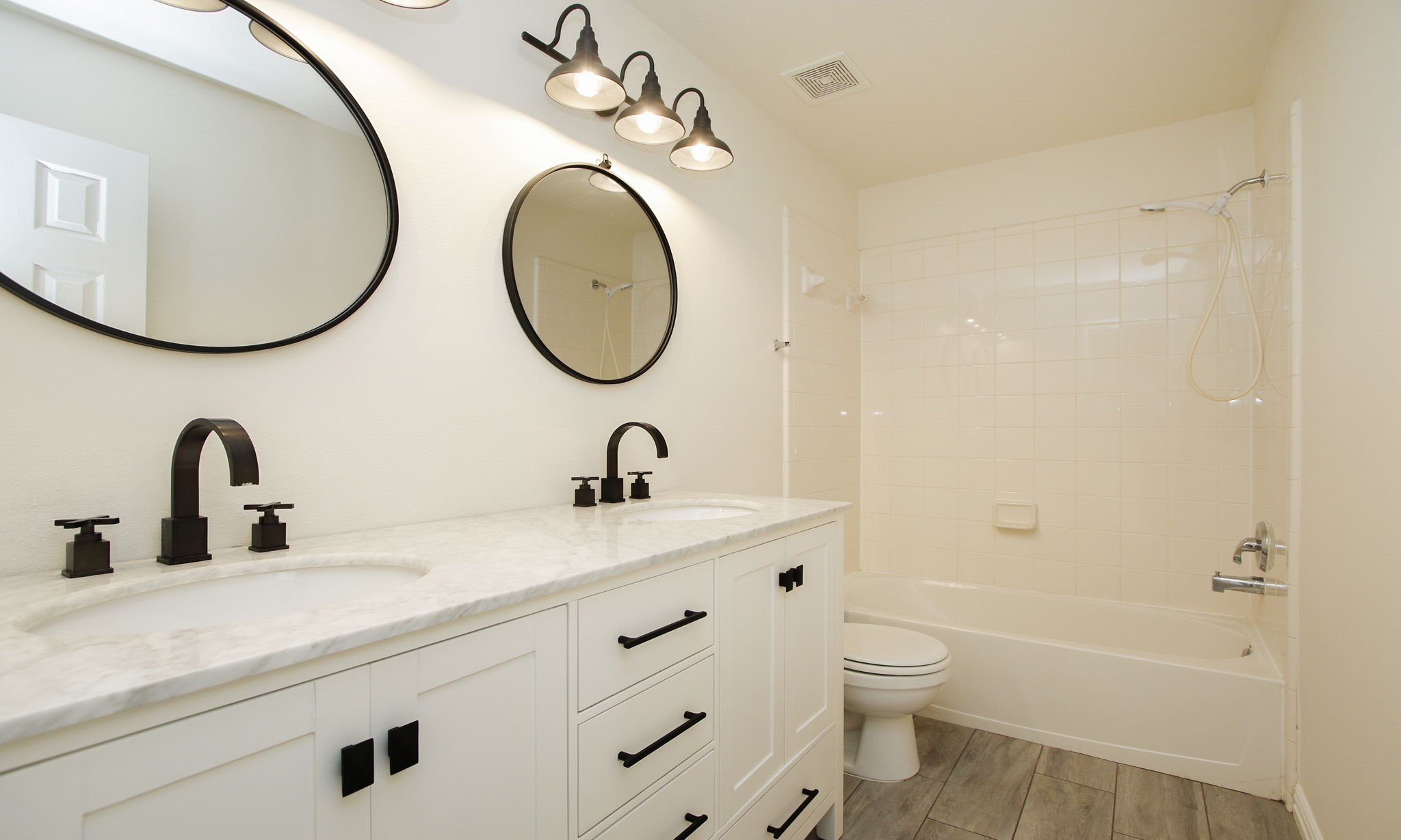 1210 Berwick Manor Court Spring, TX 77379 - Photo 7 of 50 a bathroom with a granite countertop toilet a sink and a mirror