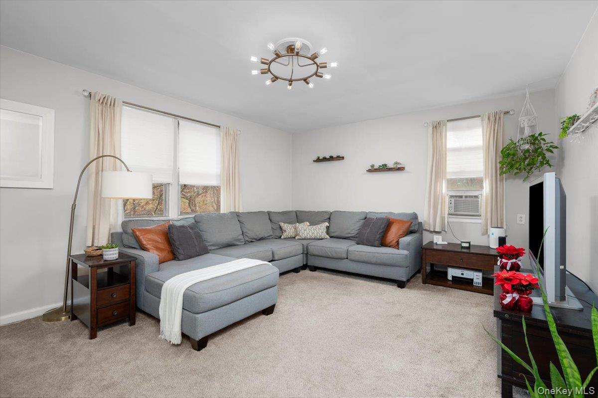 13 Bryant Crescent, Unit 2K White Plains, NY 10605 - Photo 12 of 29 a living room with furniture and a flat screen tv