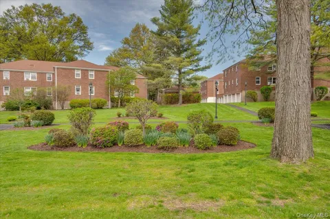 a view of a garden with a house in the background