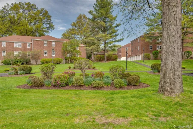 a view of a garden with a house in the background
