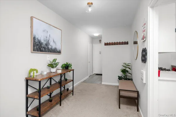 a hallway with a dining table and chairs
