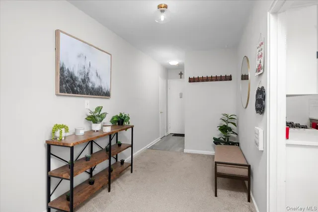 a hallway with a dining table and chairs
