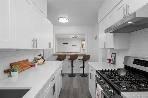 a kitchen with a sink stove and cabinets