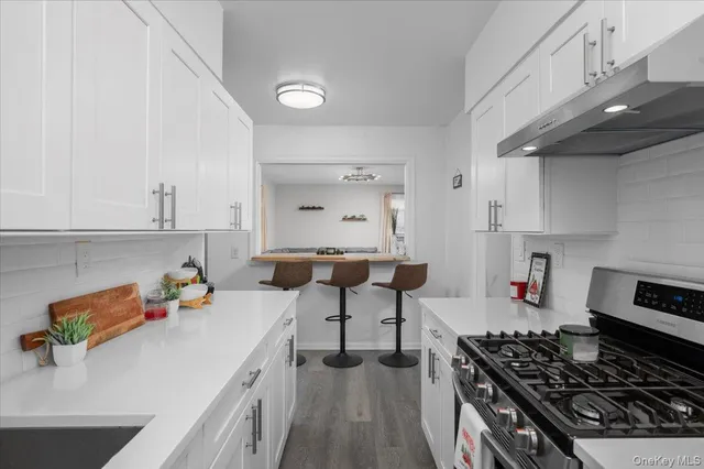 a kitchen with a sink stove and cabinets