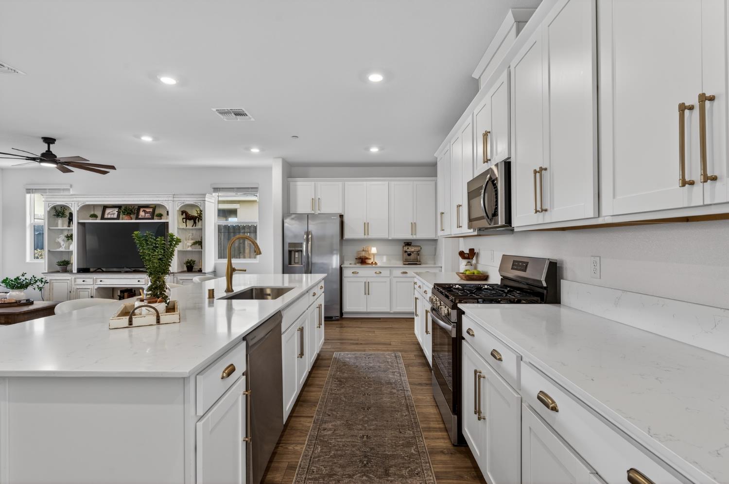 4498 Duckhawk Circle Rancho Cordova, CA 95742 - Photo 16 of 61 a kitchen with white cabinets sink and stove