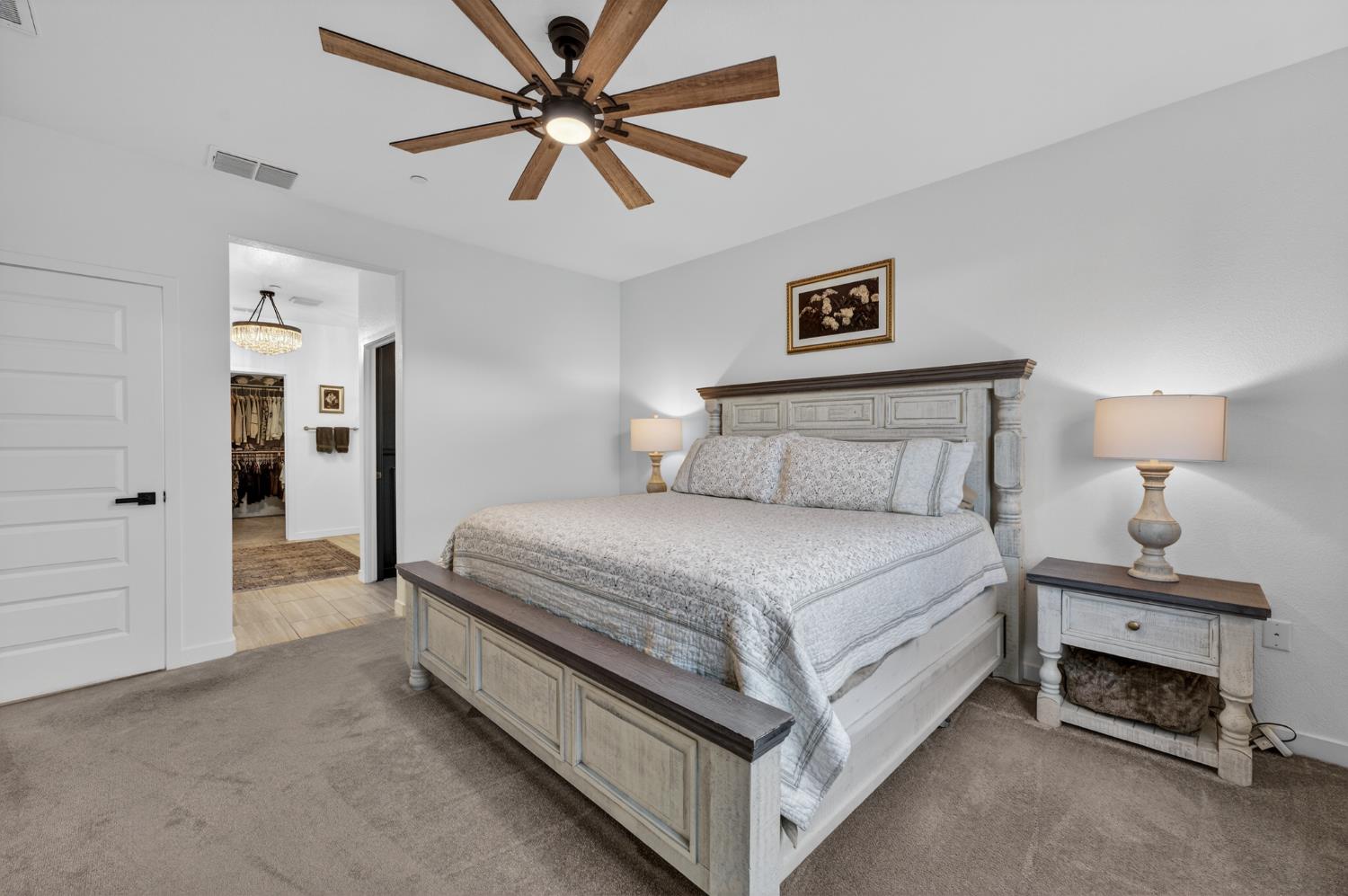 4498 Duckhawk Circle Rancho Cordova, CA 95742 - Photo 22 of 61 a bedroom with a bed and a chandelier