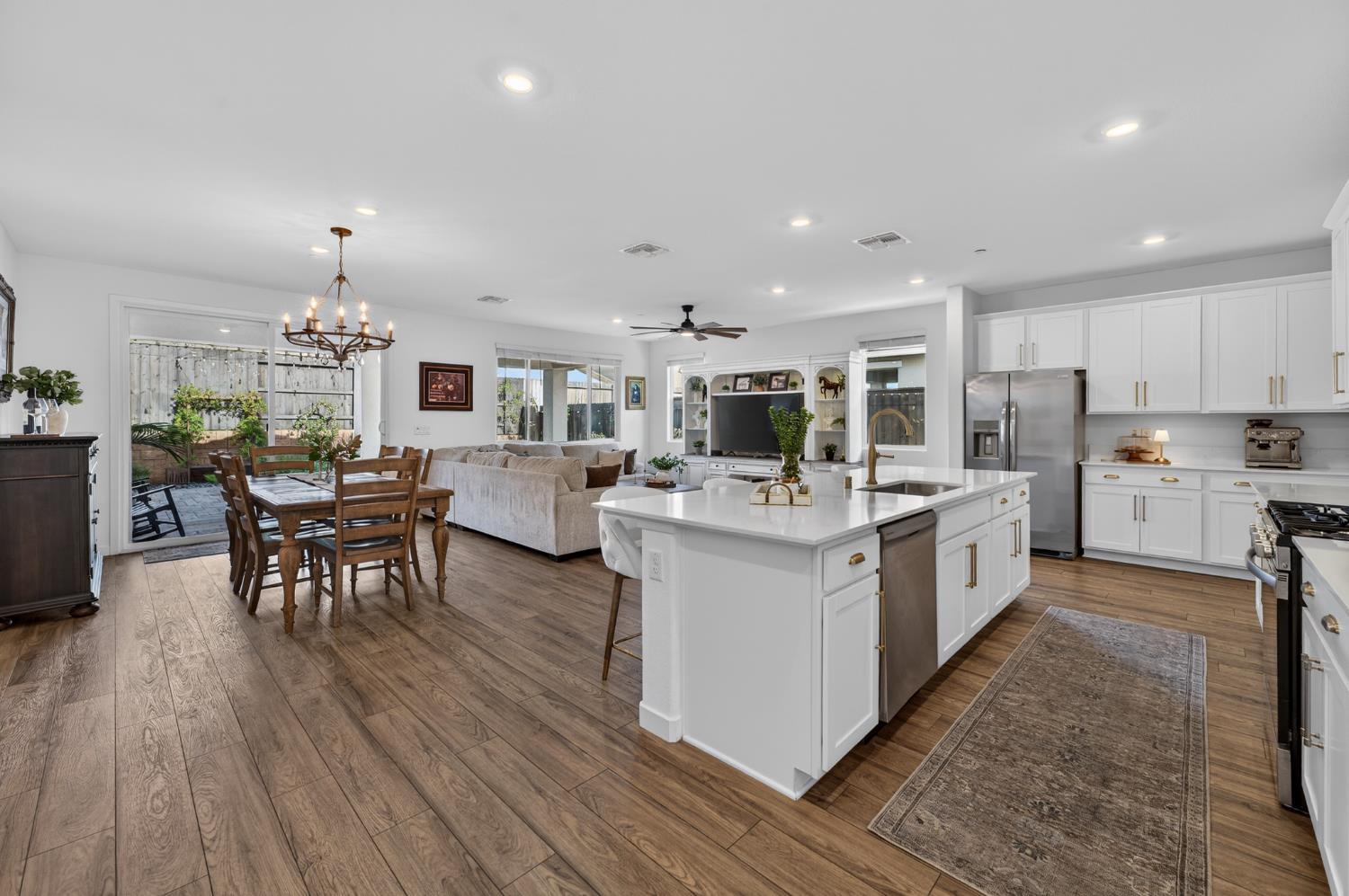 4498 Duckhawk Circle Rancho Cordova, CA 95742 - Photo 9 of 61 a living room with furniture a dining table wooden floor and kitchen view