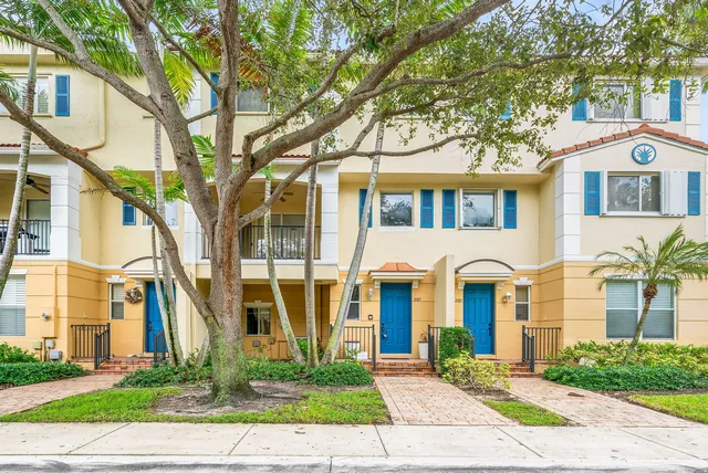 a front view of a residential houses with yard