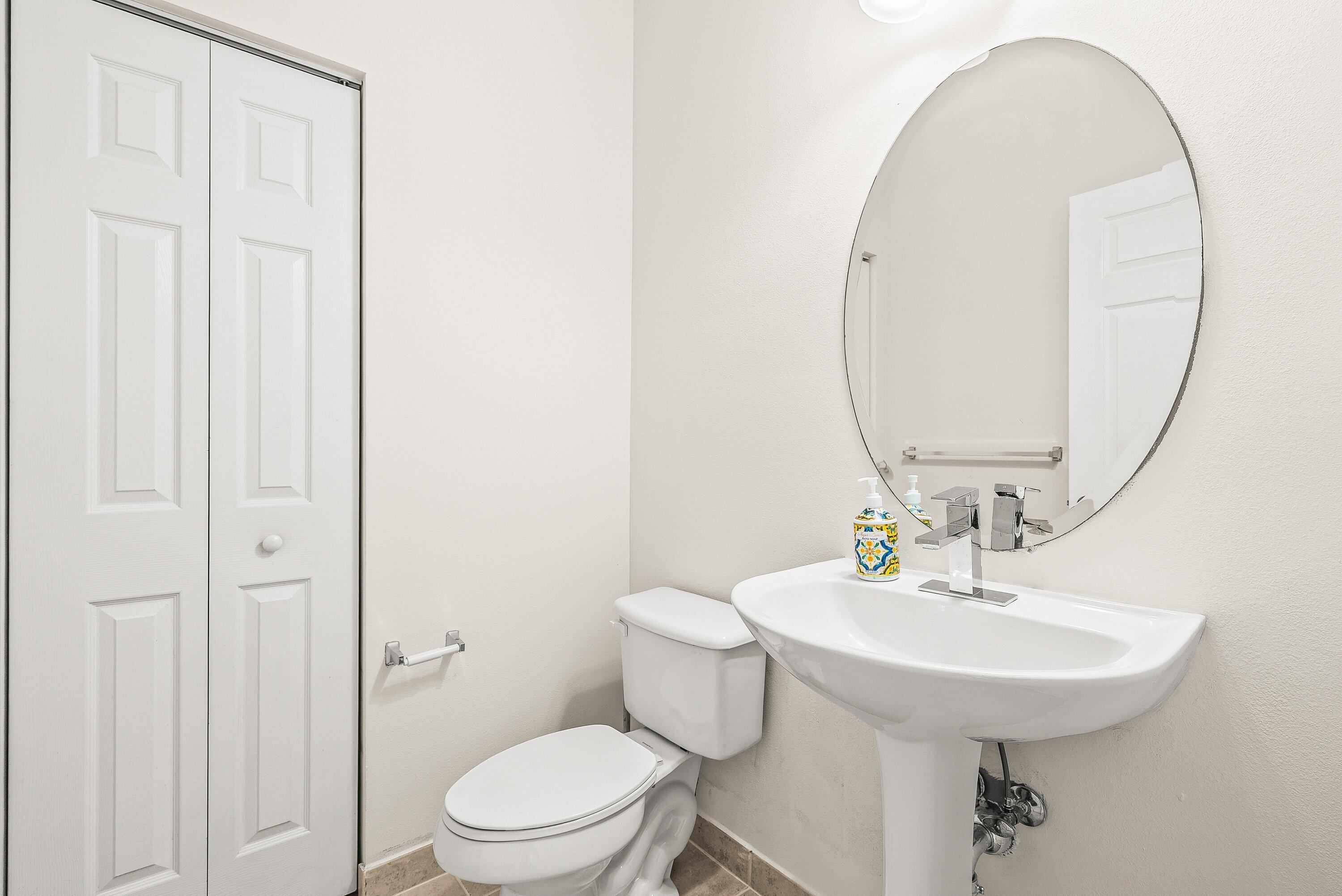3187 North Oasis Drive Boynton Beach, FL 33426 - Photo 14 of 41 a bathroom with a sink a toilet and a mirror