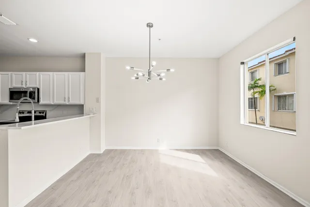 a view of a kitchen with microwave and refrigerator