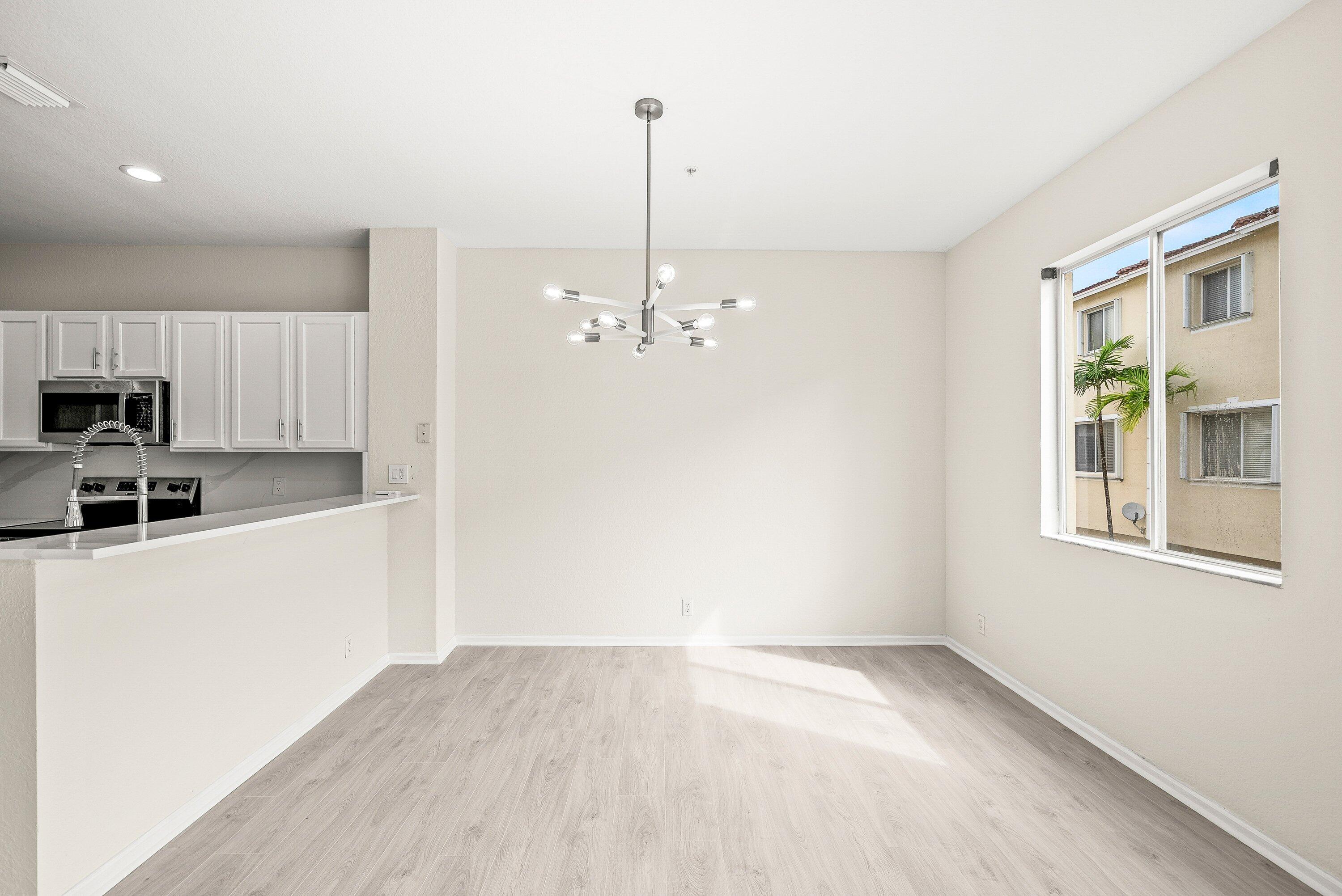 3187 North Oasis Drive Boynton Beach, FL 33426 - Photo 6 of 41 a view of a kitchen with microwave and refrigerator