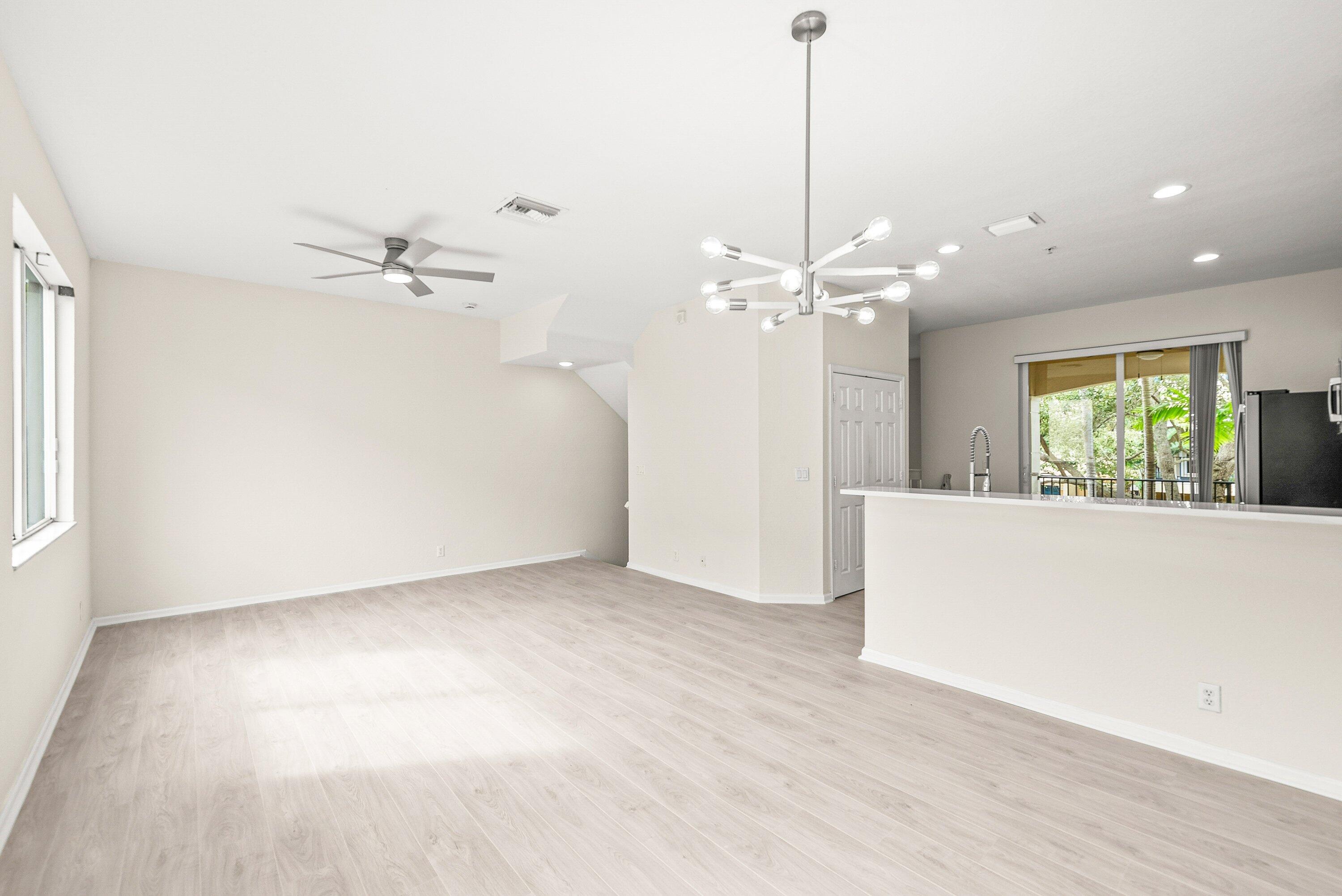 3187 North Oasis Drive Boynton Beach, FL 33426 - Photo 7 of 41 a view of a livingroom with a ceiling fan window and hardwood floor