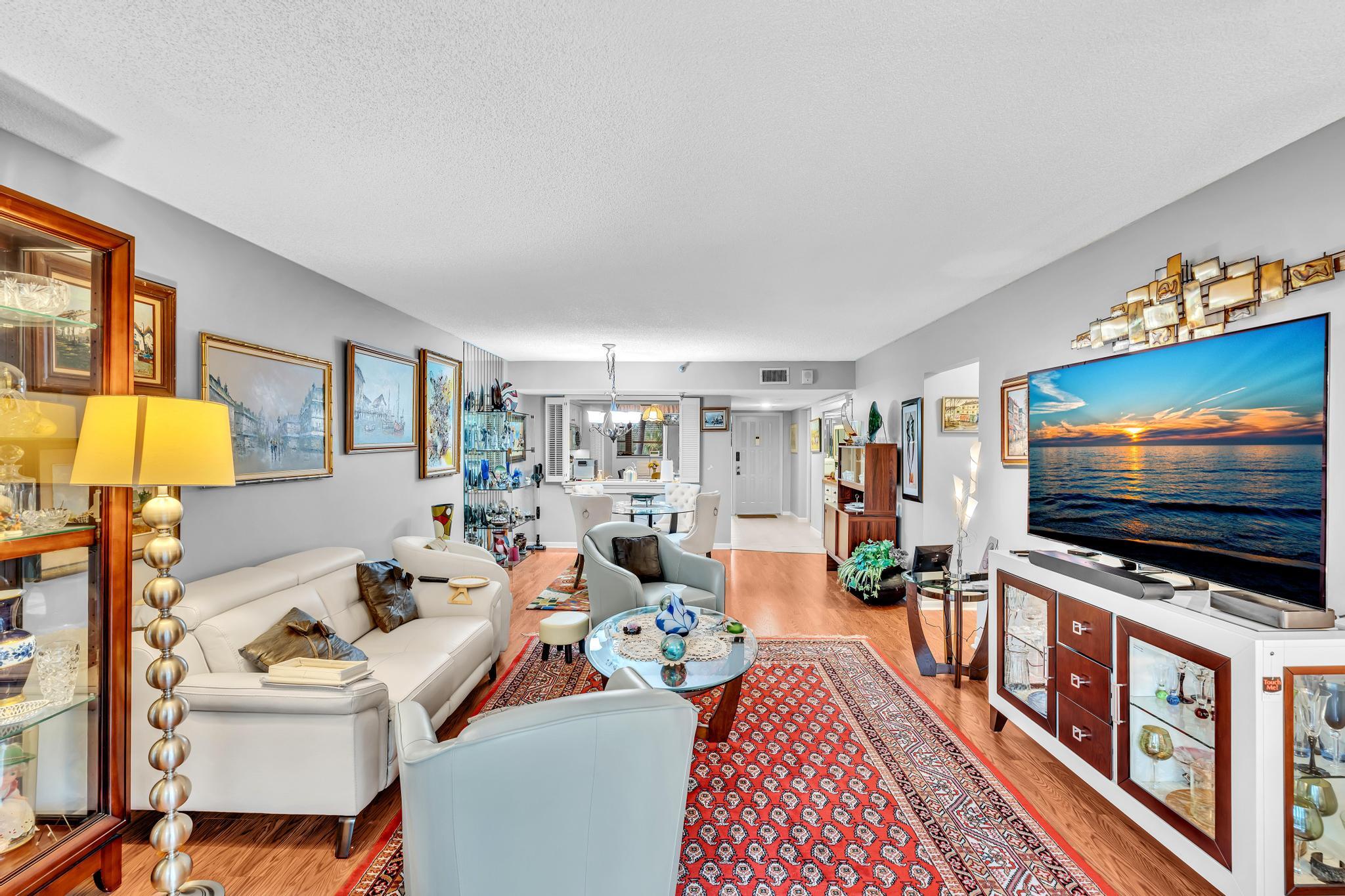 6320 Boca Del Mar Drive, Unit 303 Boca Raton, FL 33433 - Photo 20 of 42 a living room with furniture and a flat screen tv