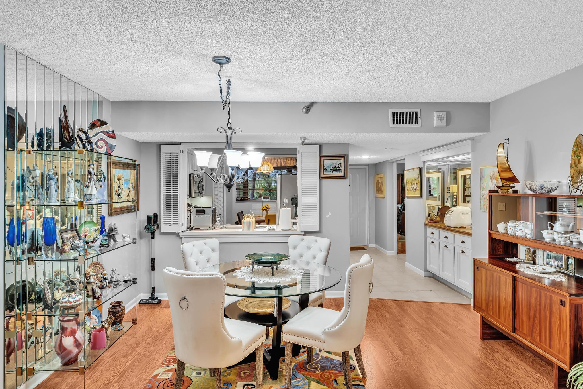 6320 Boca Del Mar Drive, Unit 303 Boca Raton, FL 33433 - Photo 21 of 42 a view of a dining room with furniture window and wooden floor