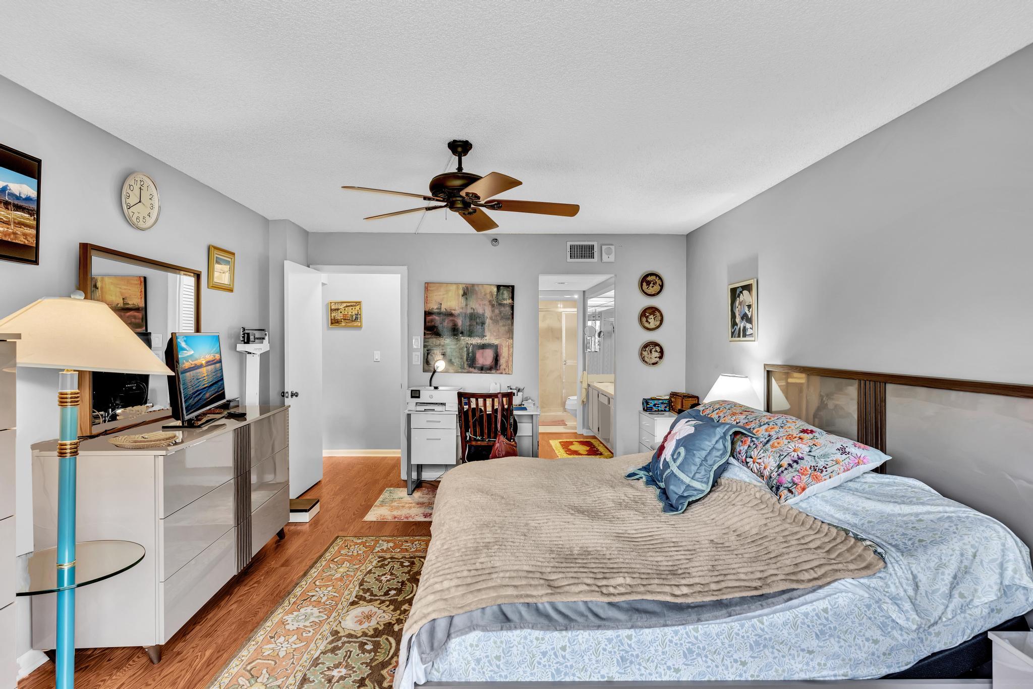 6320 Boca Del Mar Drive, Unit 303 Boca Raton, FL 33433 - Photo 23 of 42 a bed room with a bed and a chandelier