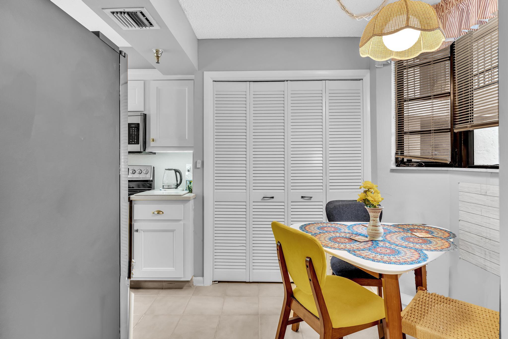 6320 Boca Del Mar Drive, Unit 303 Boca Raton, FL 33433 - Photo 5 of 42 a view of a dining room with furniture and chandelier