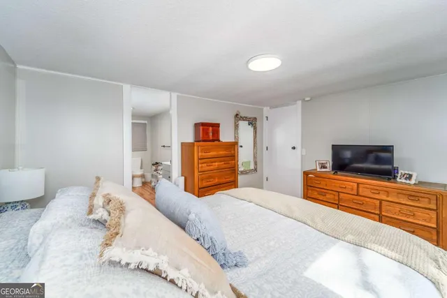 a bedroom with a bed and a television