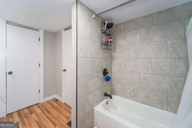 a bathroom with a bathtub and shower