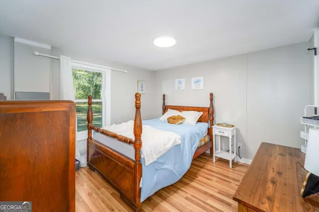 a bed room with a bed and a window