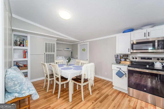 a view of a dining room with furniture and wooden floor