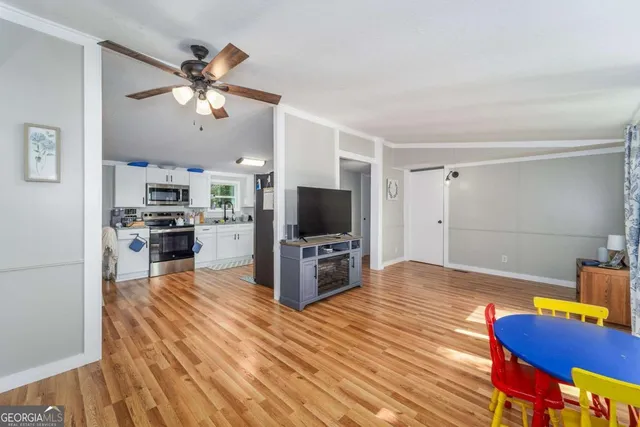 a view of a living room kitchen and a wooden floor