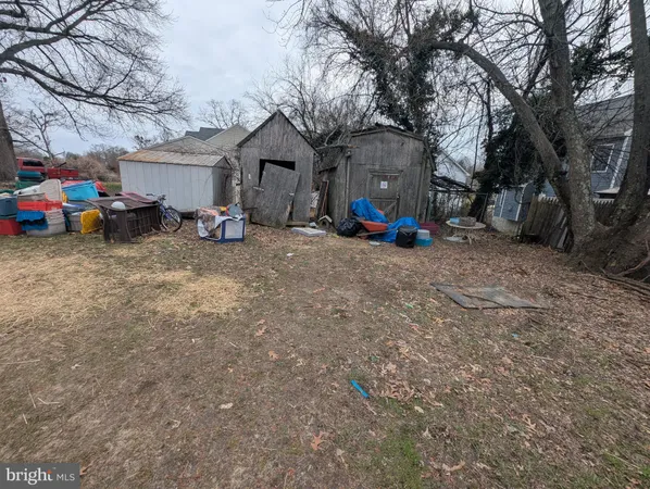 a view of a house with a yard and car parked
