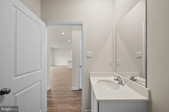a bathroom with a sink a mirror and shower
