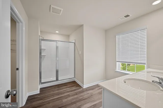 a bathroom with a tub sink and a window