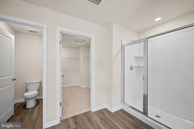 a bathroom with a shower and a toilet