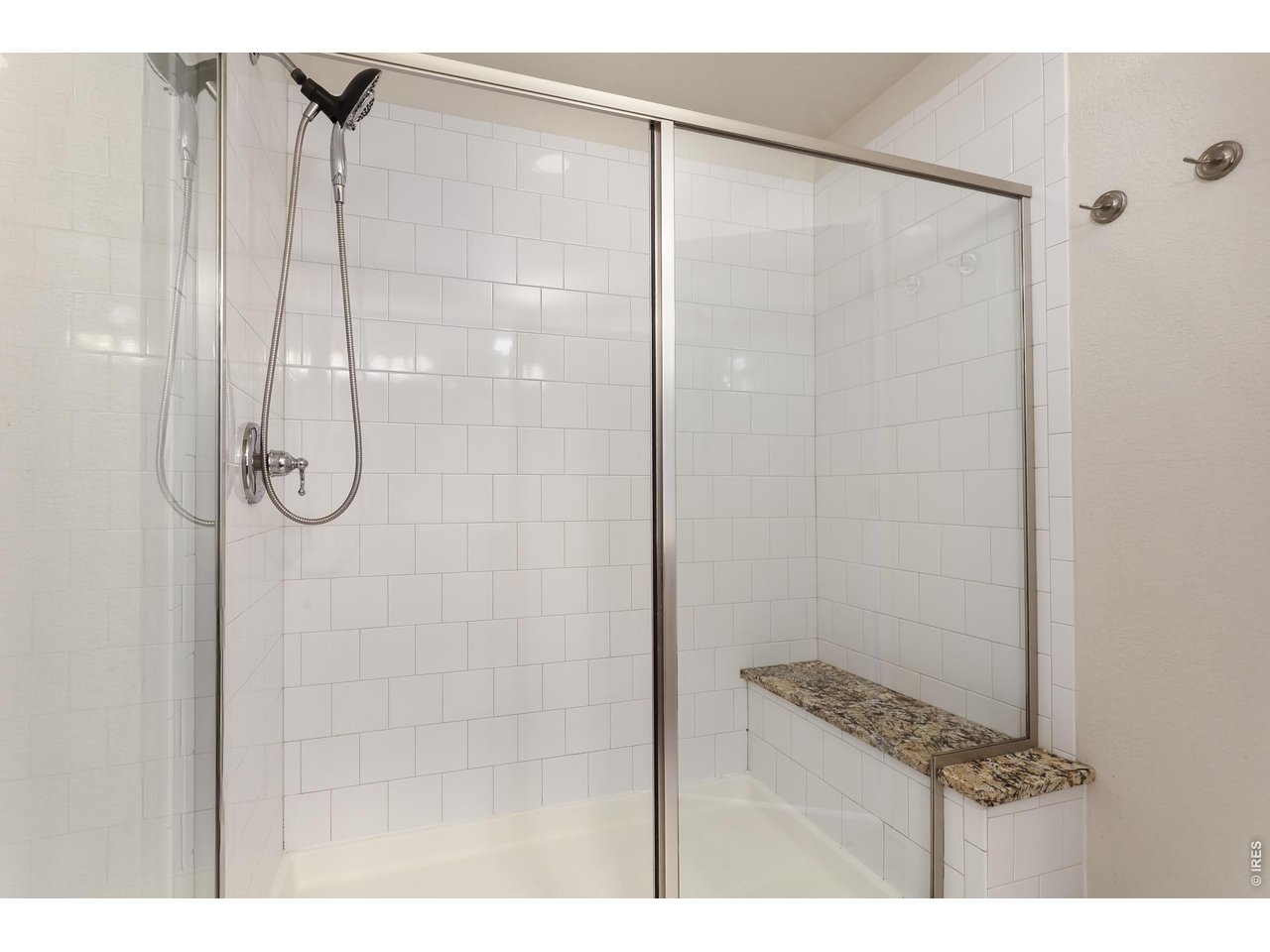 610 Stonebridge Drive Longmont, CO 80503 - Photo 15 of 30 a bathroom with a glass shower door