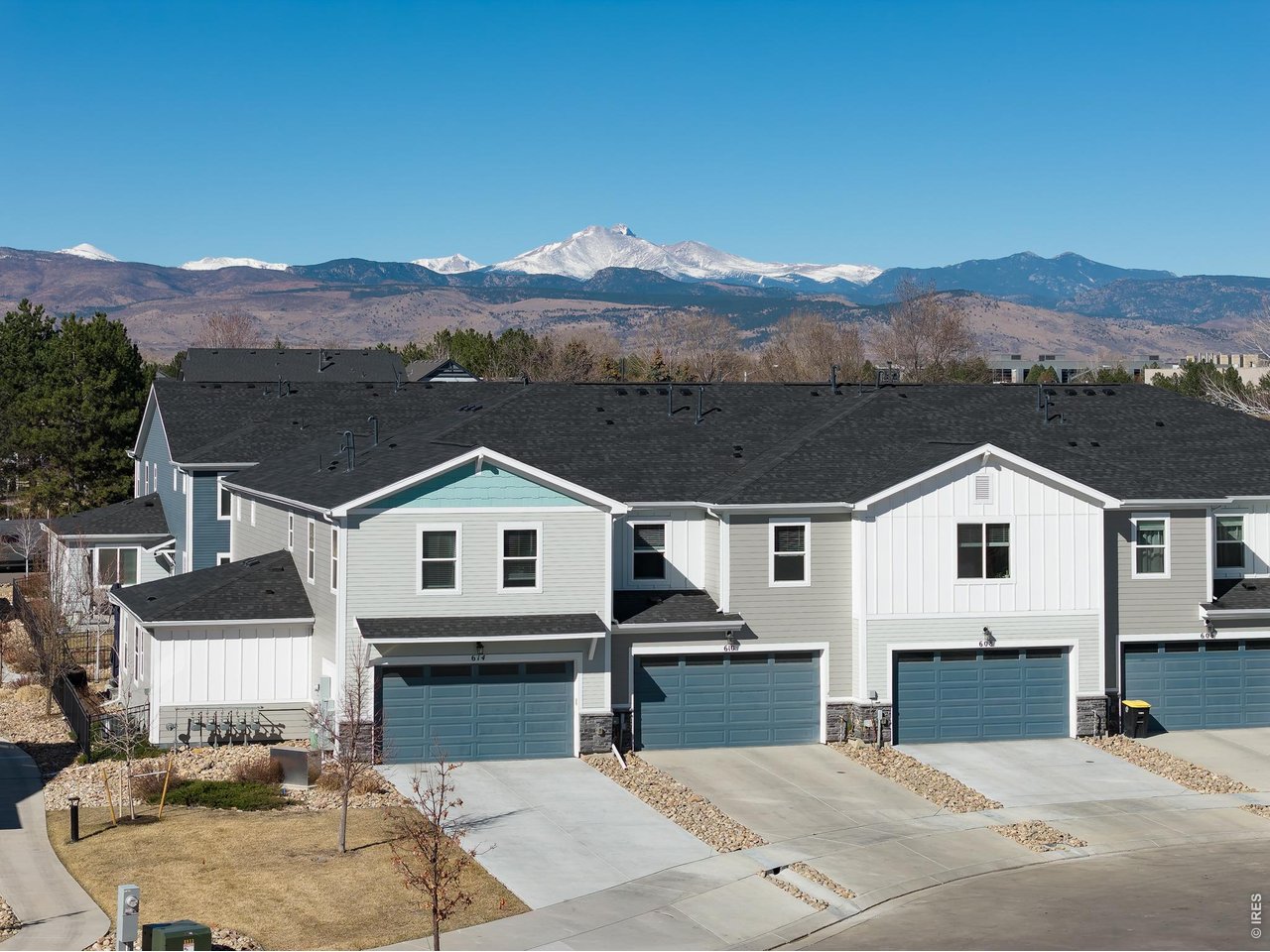 610 Stonebridge Drive Longmont, CO 80503 - Photo 5 of 30 a view of a big house with a big yard and large trees