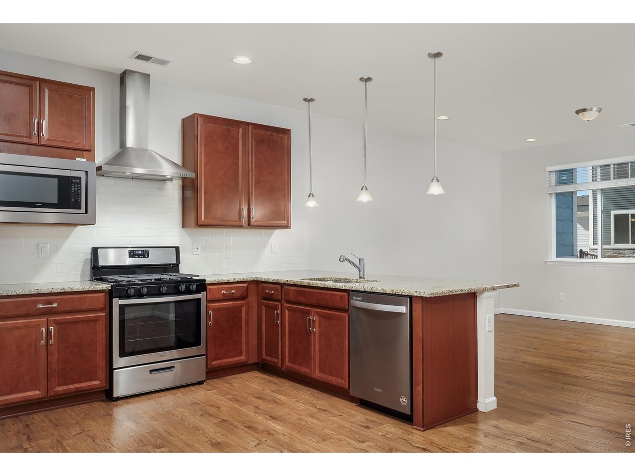 610 Stonebridge Drive Longmont, CO 80503 - Photo 10 of 30 a kitchen with stainless steel appliances granite countertop a stove a sink and a microwave