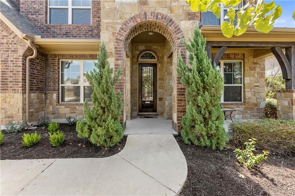 a view of a house with potted plants