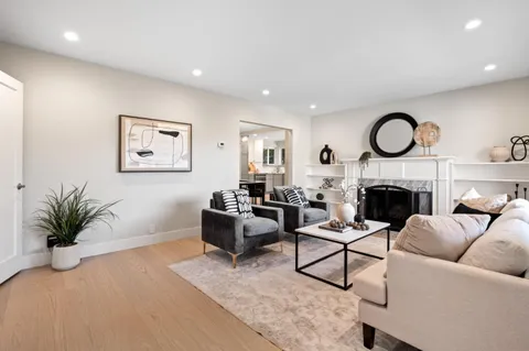 a living room with furniture a fireplace and a flat screen tv